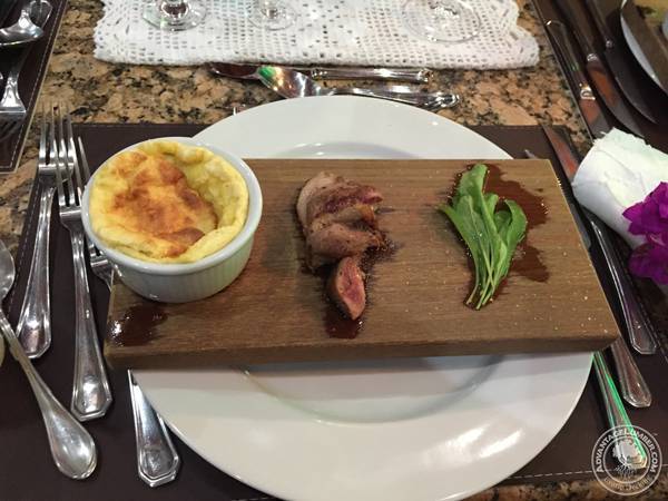 Steak and vegetables with dressing sitting directly on top of ipe.