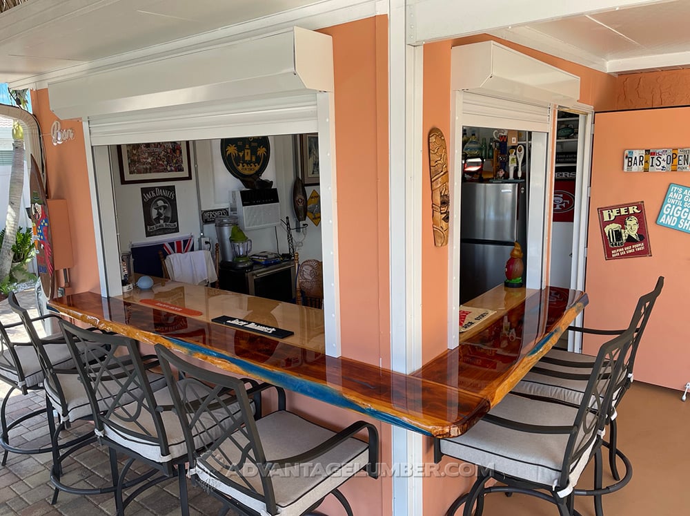 cedar wood slab with blue epoxy used as a bar top in an outdoor bar
