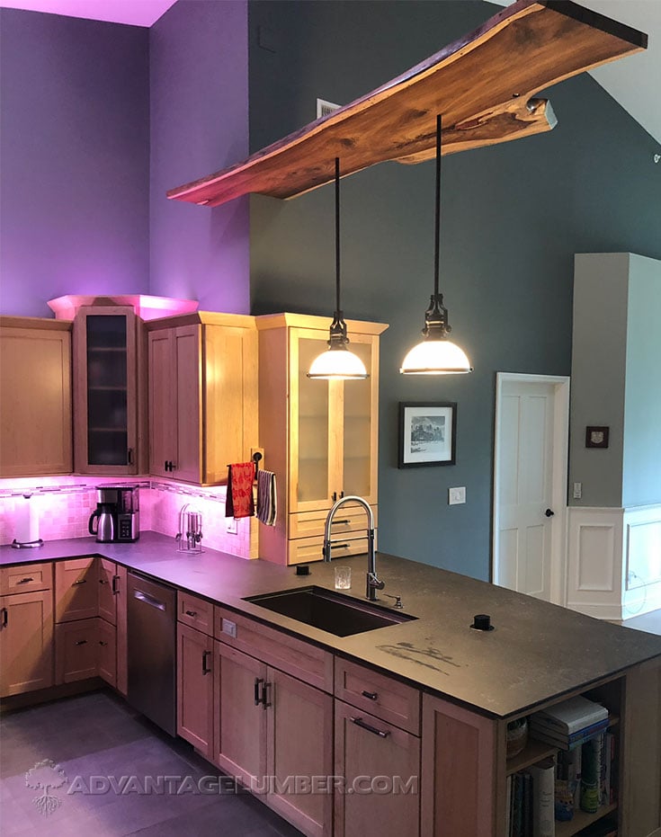 live edge indian rosewood sab used as a lighting feature above a kitchen peninsula