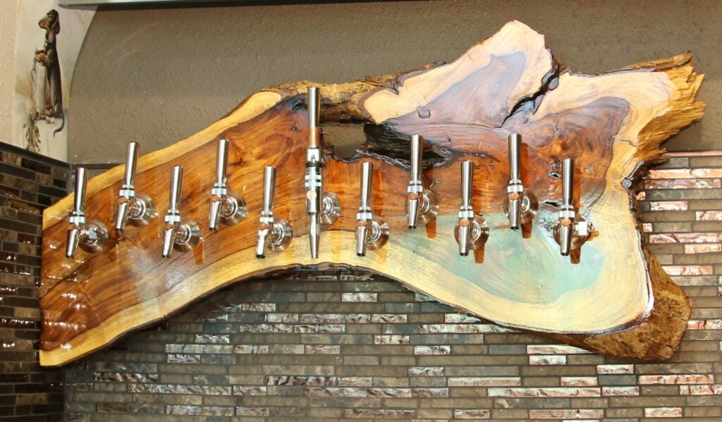 indian rosewood wood slab transformed into a decorative tap wall for a bar