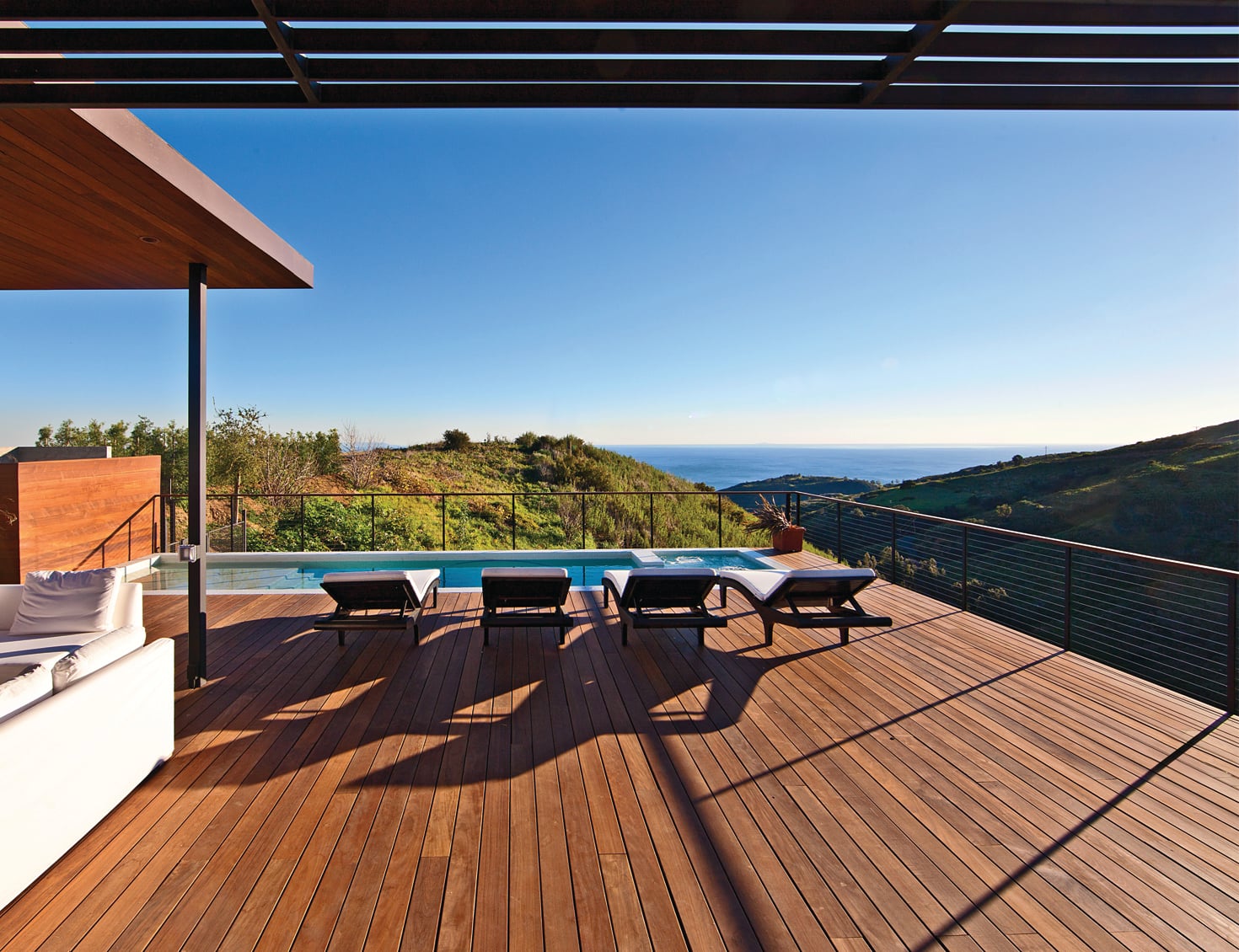 Hardwood deck with cable railing and pool